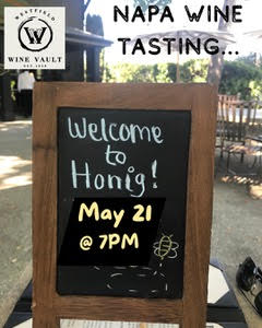 Chalkboard sign announcing Honig wine tasting: 'Welcome to Honig! May 21 @ 7PM' with Wine Vault logo.